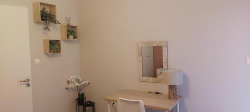 a desk with a mirror and a table with chairs at Hermes green in Artemida