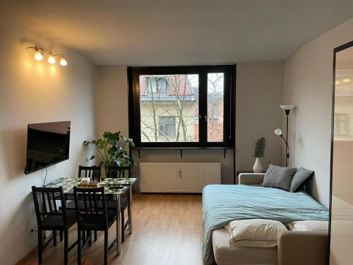 a living room with a bed and a table at Apartment in Ljubljana center in Ljubljana