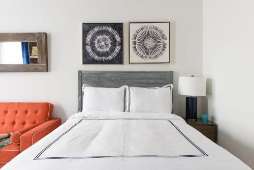 a bedroom with a bed and a orange chair at 26-3A STUDIO Gramercy W D Outdoor Courtyard in New York