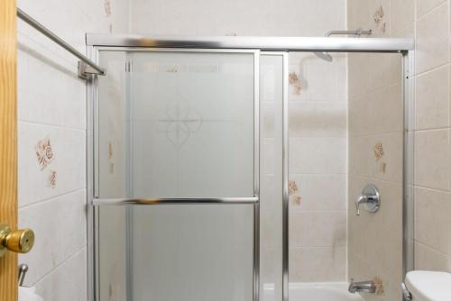 a shower with a glass door in a bathroom at 26-3A STUDIO Gramercy W D Outdoor Courtyard in New York