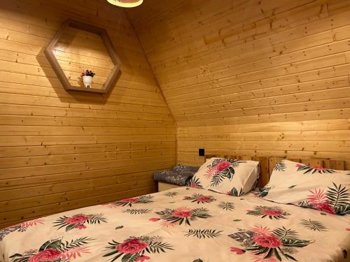 a bedroom with a bed in a wooden cabin at A Frame Lankaran in Lankaran