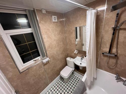 a bathroom with a toilet and a sink at Chapter Homes Newcastle in Saint Peters