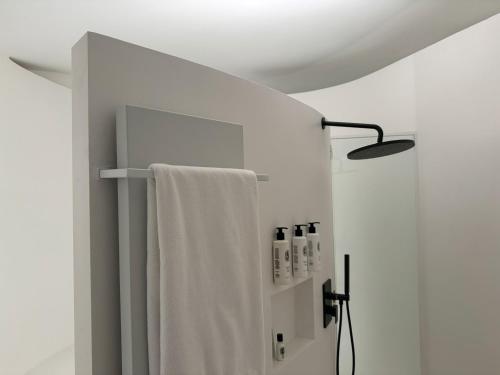 a bathroom with a towel hanging on a wall at Hotel Palazzo Durazzo Suites in Genova