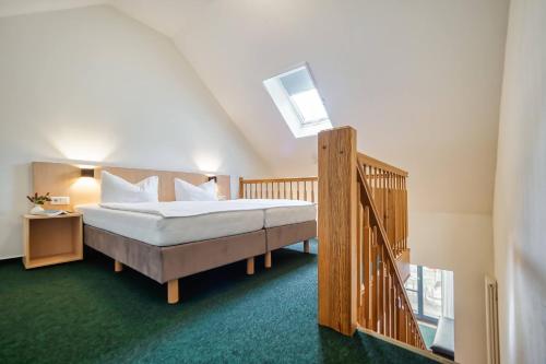 a bedroom with a large bed and a staircase at Familienferienpark Dambeck in Kratzeburg