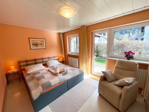 a small bedroom with a bed and a chair at Ferienwohnung Singer in Bad Reichenhall