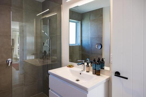 a bathroom with a sink and a shower at The Apartment at Arrowtown in Arrowtown