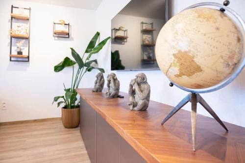 a large globe on a table with figurines on it at Stijlvol appartement met jacuzzi & sauna in Herk-de-Stad