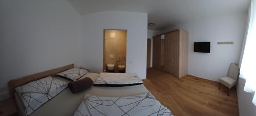 a room with a bed and a television in it at Lanziner Apartments in Egna