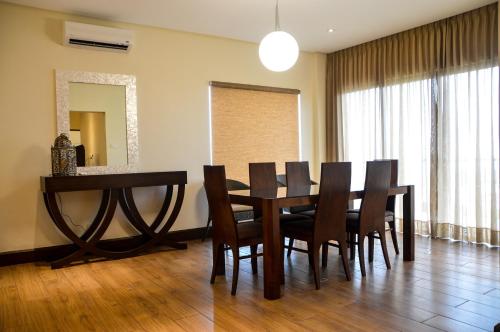 a dining room with a wooden table and chairs at Hotel Monticello Tagaytay in Tagaytay