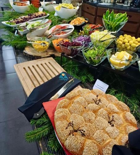 a buffet of food with bread and other foods at Local Stay Villas in Bansko