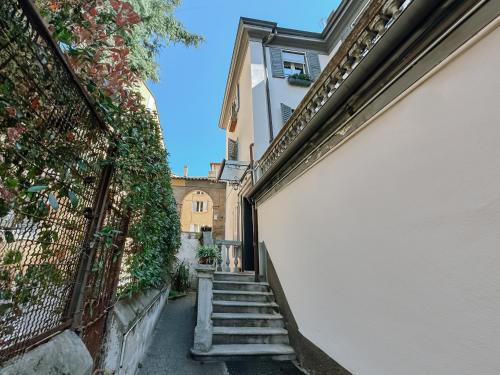 an alleyway between two buildings with stairs leading to a building at Free Parking - Modena Prestige, la Porta sul Centro in Modena