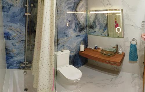 uma casa de banho com um WC e um chuveiro em Arthome - guest rooms em Gharb