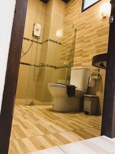 a bathroom with a toilet and a shower at Wind Beach Resort in Koh Tao