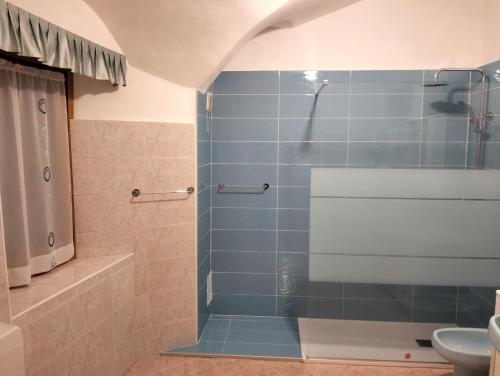 a bathroom with a shower with a glass door at App. Valentina in Segonzano