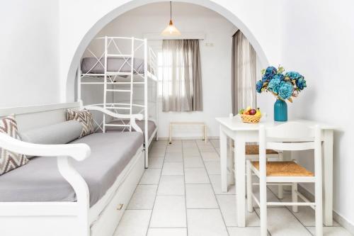 a bedroom with a bunk bed and a desk at Depis studios & apartments in Naxos Chora