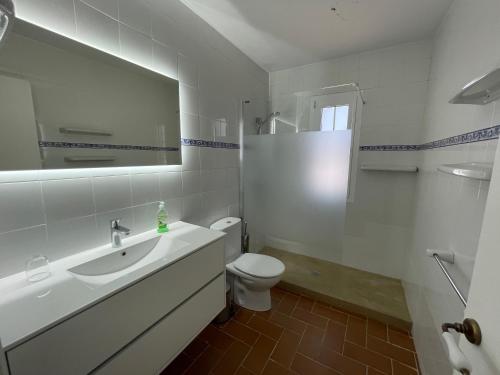 a white bathroom with a sink and a toilet at VILLASTAR by SOM Menorca in Es Mercadal