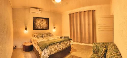 a bedroom with a large bed and a window at Knowhere Selfcatering Unit 1 in Omaruru