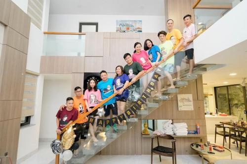 a group of people standing on a staircase at Charming Luxury Beach Villa Da Nang in Da Nang