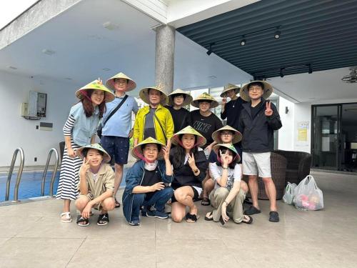 a group of children wearing hats posing for a picture at Charming Luxury Beach Villa Da Nang in Da Nang