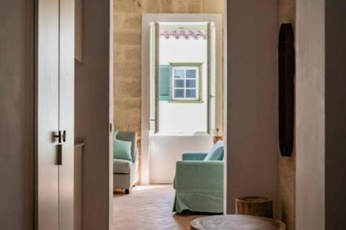 a living room with a couch and a window at Suite 2 in Mahón