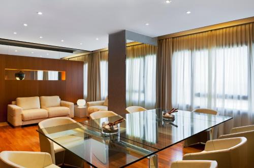 a conference room with a glass table and chairs at Four Points by Sheraton Padova in Padova