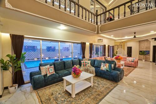 a large living room with a couch and a table at EKOSTAY Luxe - Highland Villa in Panchgani