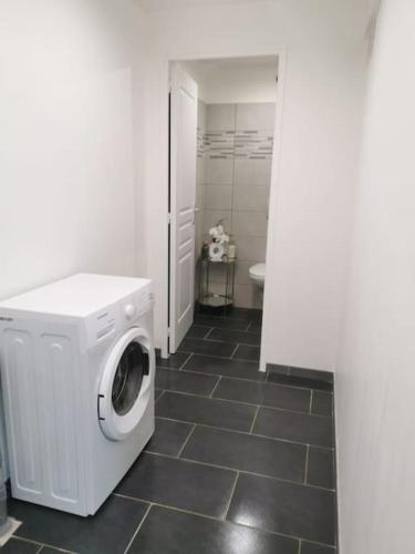 a washer and dryer in a bathroom with a tile floor at Gite De La Gâche in Saint-Christoly-de-Blaye