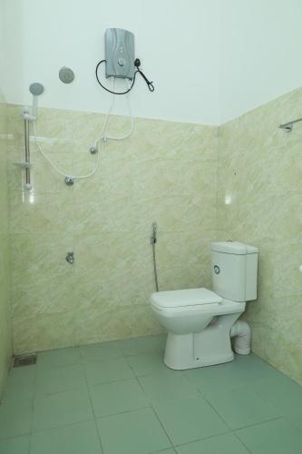 a bathroom with a toilet and a shower at Multi Villa Gold in Galle