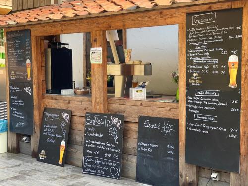 a restaurant with chalkboard signs in front of a counter at Ferienwohnung Werraquell Hütte in Masserberg