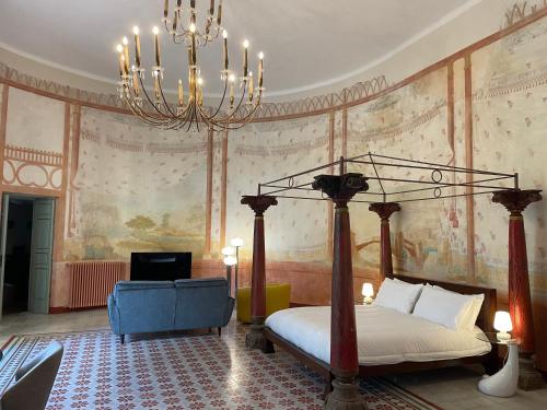 a bedroom with a bed and a chandelier at Il Sogno di Elisa in Lucca