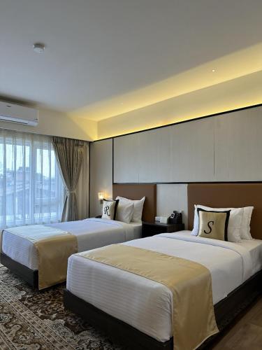 Ένα ή περισσότερα κρεβάτια σε δωμάτιο στο Shulem Boutique Hotel