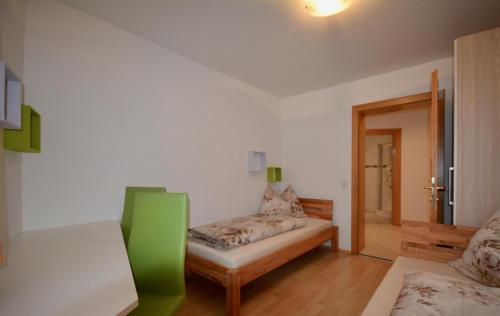 a room with a couch and a bed in it at Ferienwohnung Sonnenhang in Nußdorf