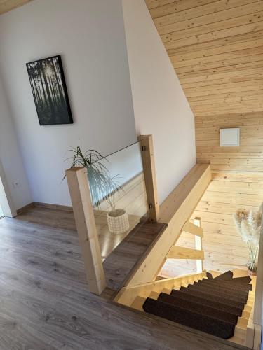 a wooden staircase in a room with a glass wall at Drevenica RELAX in Makov