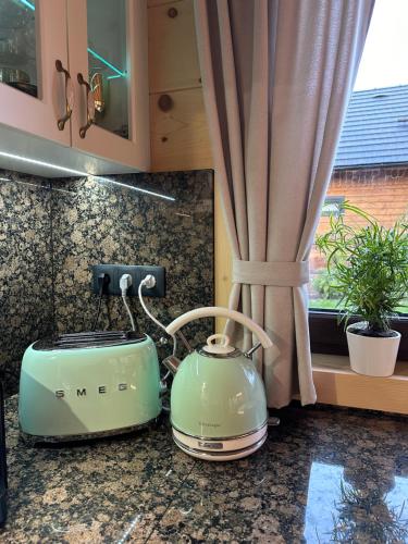 a kitchen counter with a tea kettle on a counter top at Drevenica RELAX in Makov