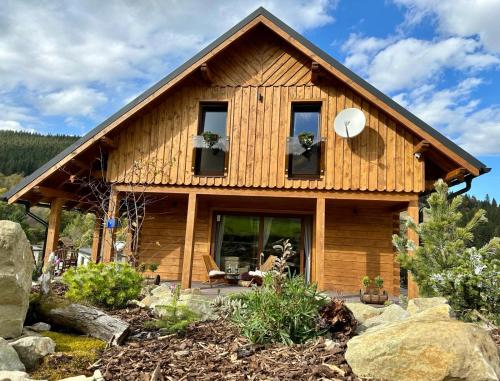 a log cabin with a porch and windows at Drevenica RELAX in Makov