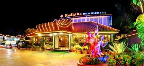 a restaurant with a statue in front of it at night at Radhika Beach Resort & Spa Diu in Nagwa