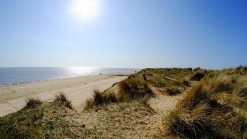 a beach with a heart in the sand at Beautiful 4 Berth Seaside Apartment On Ground Floor In Hemsby, Ref 99010fh in Great Yarmouth