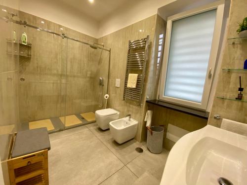 a bathroom with a toilet and a sink and a shower at Appartamento Casa Crispino Piano terra per 3 persone in Frattaminore