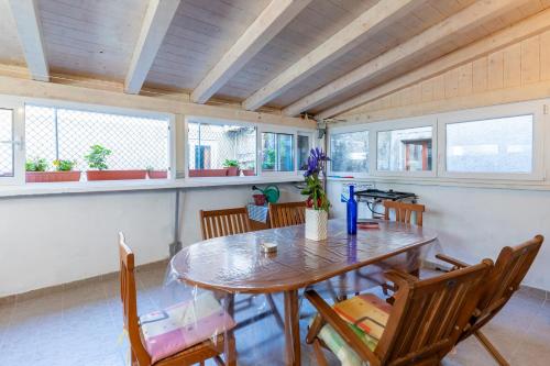 Guesthouse Romana في كريس: غرفة طعام مع طاولة وكراسي خشبية