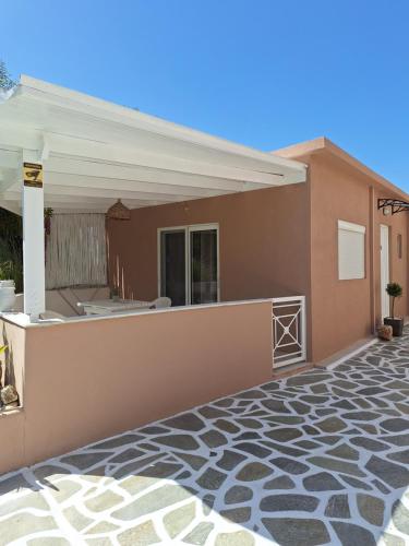 a home with a patio and a house at Bay View in Faliraki