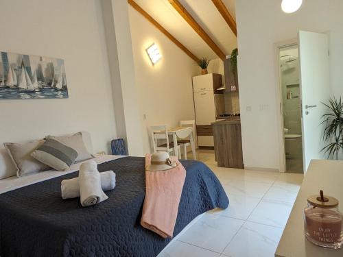 a bedroom with a bed with towels on it at Poolside Studio in Fažana