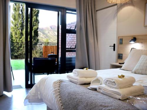 a bedroom with a bed with towels on it at Mon Cheri Clarens in Clarens