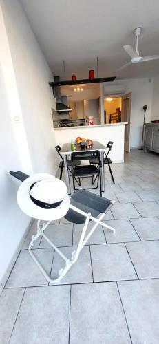 une salle à manger et une cuisine avec une table et des chaises dans l'établissement Le Petit Nénuphar plage et commerces à 400 m, au Grau-du-Roi