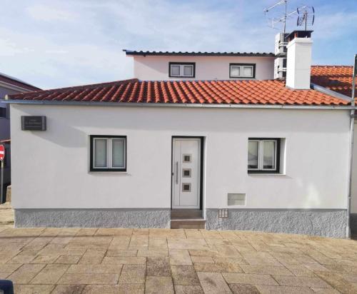 a white house with a red roof at Casa de São Miguel in Mirandela