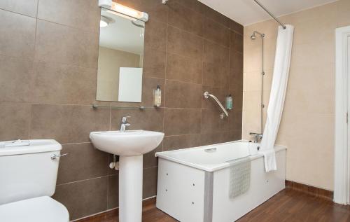 a bathroom with a sink and a toilet and a mirror at The Foley Arms Hotel Wetherspoon in Great Malvern