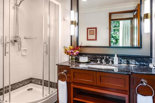 a bathroom with a shower and a sink and a tub at Treetops Executive Residences in Singapore