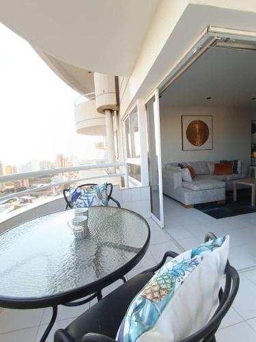 a balcony with a table and chairs and a couch at LagunaSuite & More in Porlamar