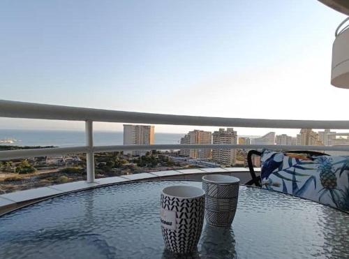 a swimming pool on a balcony with a view of the city at Laguna Suite & More in Porlamar
