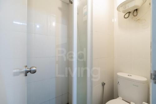 uma casa de banho branca com um WC e um chuveiro em RedLiving 19 Avenue Apartment by RH Room em Tangerang