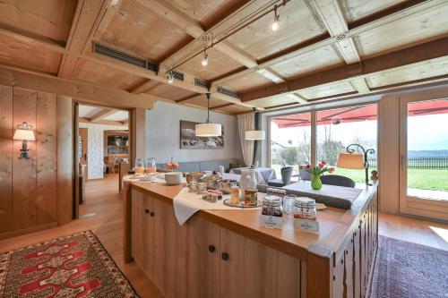 an open kitchen with a large island in a house at Pension Heim in Seeg